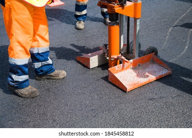 Checking the quality of road asphalt. Using a special tool, samples are taken to measure the thickness and quality of the asphalt surface
