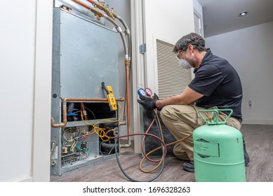 Checking Refrigerant Charge On A Heat Pump, Wearing A Safety Mask And Glasses