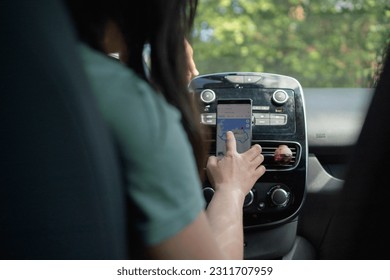 Checking the route on the map, inside the car, before leaving on the trip