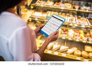 Checking Schedule. Close Up Of Busy Young Businesswoman Holding Tablet And Checking Her Schedule