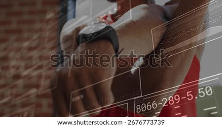 Checking smartwatch data man wearing red tank top tracking digital fitness charts in workout studio. Activewear, technology, health, analytics, fitness, digital, modern