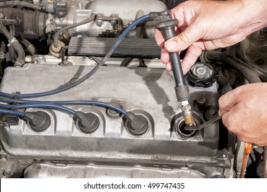 Checking A Spark Plug In A Car Engine