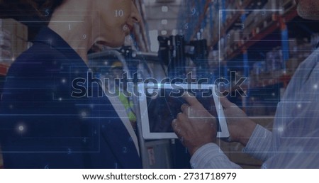 Checking tablet, worker reviewing logistics in warehouse aisle, showing HUD, blazer, vest, hard hat. Supplychain, inventory, distribution, supervisor, teamwork, racking, touchscreen