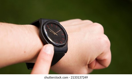 checking time pointing finger at watch
