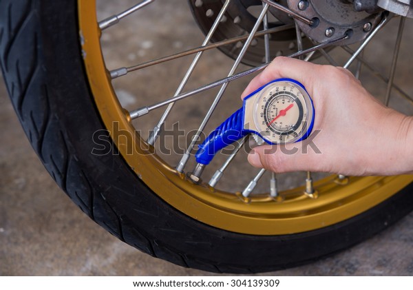 checking tire air pressure with meter gauge\
before traveling for\
multipurpose