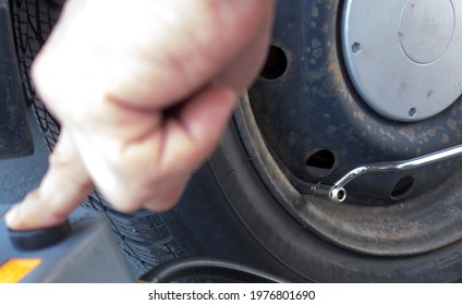 Checking The Tire Inflation Pressure Of A Car And Inflate Tire With Air