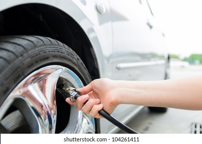 Checking Tire Pressure. Pumping Air Into Auto Wheel. Vehicle Safe Concept.