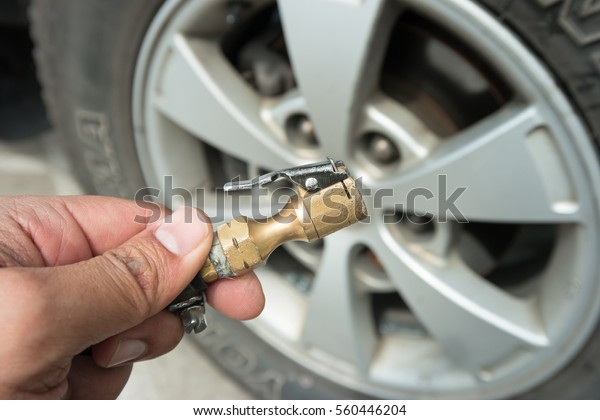 Checking tire pressure. Pumping air into auto\
wheel. Vehicle safe\
concept.