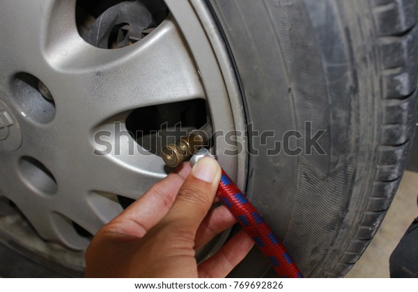 pumping air into car tires