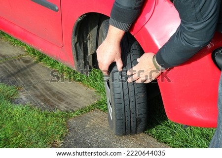 Checking the tread depth on a vehicle tyre or tire.