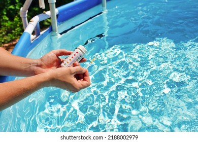 Checking The Water Quality Of A Pool With The Help Of A Test Strip With PH Value, Chlorine And Algaecide