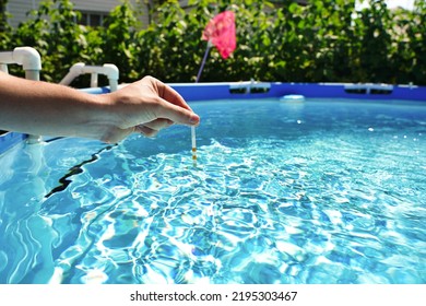 Checking The Water Quality Of A Pool With The Help Of A Test Strip With PH Value, Chlorine And Algaecide