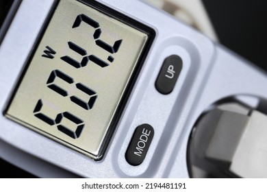 Checking wattage with wattmeter at power plug for electric energy consumption and costs - Shutterstock ID 2194481191