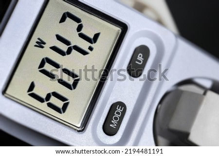 Checking wattage with wattmeter at power plug for electric energy consumption and costs