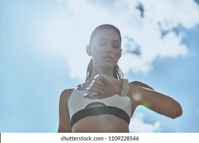 Checking Workout Results. Attractive Young Woman In Sports Clothing Checking Pedometer While Standing Outdoors