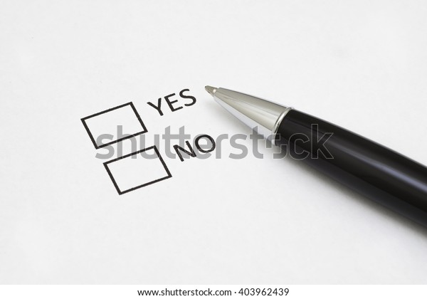 Checklist box with a pen and word YES and NO on\
white paper