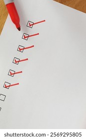 Checklist boxes close up with red ticks and marker