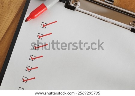 Checklist boxes close up with red ticks and marker