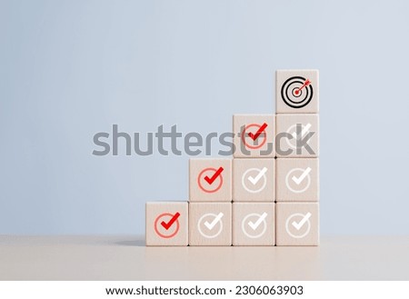 Checklist, Complete Task list. Goals achievement or enterprise objective target for company success. To do list. Check mark and dartboard from top of wooden cube stacks. Keys for success in business.