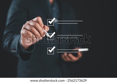 Checklist concept, Businessman checking mark on the check boxes with marker red, filling online form and answering questions. List options business employee security procedures followed office.