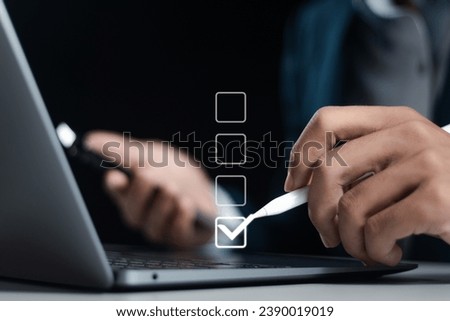 Checklist concept. Businessman using laptop for checking mark on checkboxes.