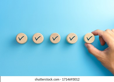Checklist concept, Check mark on wooden blocks, blue background with copy space - Shutterstock ID 1714693012