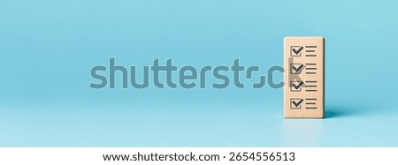 Checklist concept, Check mark on wooden blocks, blue background with copy space