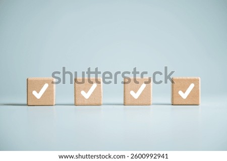 Checklist management plan. Tick answer on checkbox. Plan by check the list report and progress. Four wooden blocks with white check marks on them. The blocks are arranged in a row.