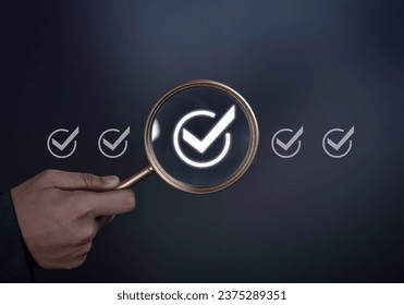 Checklist quality standards or audit quality control concept. Magnifying glass focus on checkmark icon show check the authenticity business for certification of conduct rules.