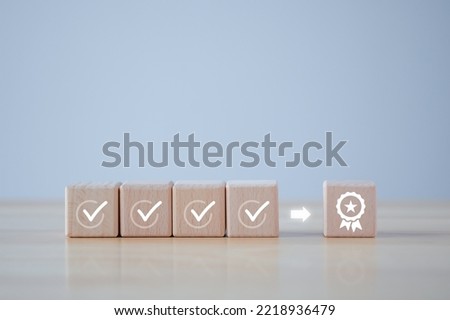 Checklist and sign of the top service Quality assurance on wooden blocks. Guarantee, Standards, ISO certification, standardization concept, advertising product and service quality commitment. 