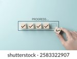 Checklist and task progress tracking concept. A hand placing the final checkmark on wooden blocks in a progress bar, task completion, productivity, goal setting, and efficient project management.