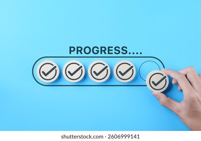 Checklist and task progress tracking concept. A hand placed the final checkmark on round wooden in progress bar, task completion, productivity, goal setting, efficient project management, loading bar,