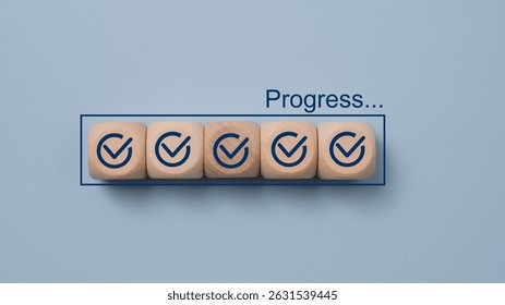 Checklist and task progress tracking concept. Wooden blocks with check marks are arranged in a bar with the word progress. task completion, productivity, and efficient project management.