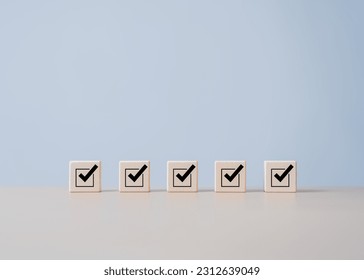 Checklists, Reminder App, Task lists, Survey, assessment online forms. Goals achievement and business success. Company objective achievement and business success. Check mark icon on wooden blocks.