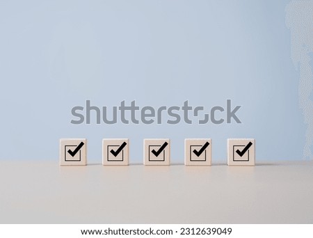 Checklists, Reminder App, Task lists, Survey, assessment online forms. Goals achievement and business success. Company objective achievement and business success. Check mark icon on wooden blocks.