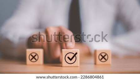 Checkmark and cross icons on wooden cubes on white background. Regulatory compliance, project feasibility concept. Tick and cross signs,approve and disapprove symbols.