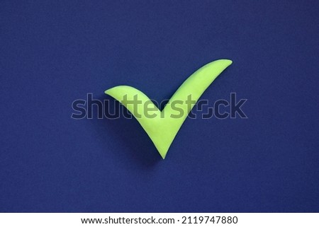 Checkmark sign on blue background. Concept of well done, confirmation or approval, positive answer. 