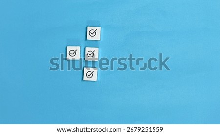 Checkmarks on white squares represent checklist task management completion approval success and validation against a blue background indicating items are done.