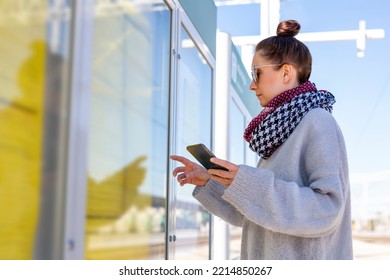 Checks The Train Timetable. The Woman On The Platform.