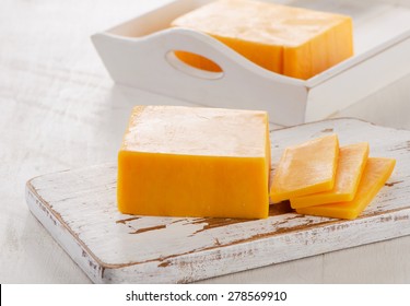 Cheddar Cheese On  Cutting Board. Selective Focus