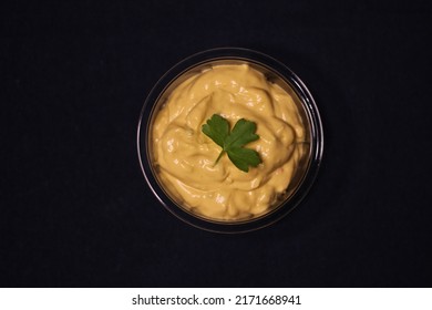 Cheddar Cheese Sauce For Dipping Nachos With Coriander Leaf Mexican Food With Dark Background