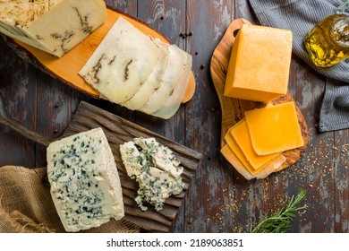 cheddar cheese sliced, moliterna cheese with black truffles, dor blue cheese on boards top view - Powered by Shutterstock