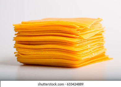 Cheddar Cheese Slices Close Up On White Background