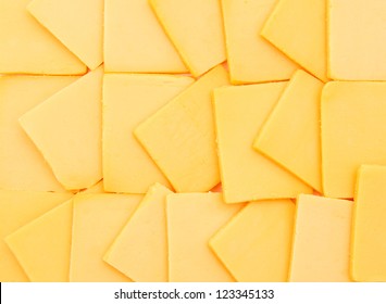 Cheddar Cheese Slices On  Background.
