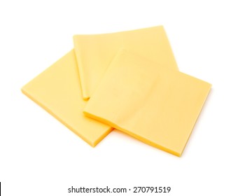 Cheddar Cheese Slices On White Background.