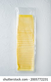 Cheddar Cheese In Vacuum Pack, On White Background