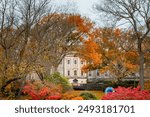 Cheekwood Estate mansion building architecture surrounded by colorful fall foliage trees. Photo taken in Nashville Tennessee during Autumn