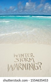 Cheeky Winter Storm Warning? Message Handwritten On Tropical Beach To Make The Friends At Home Envious