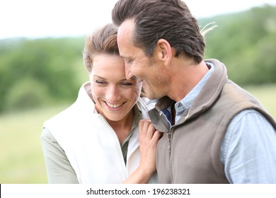 Cheerful 40-year-old Couple Walking In Countryside