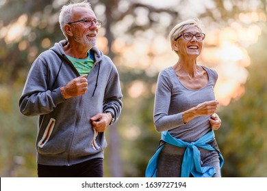 Cheerful active senior couple exercising in the park together. Exercise to stop aging. - Powered by Shutterstock